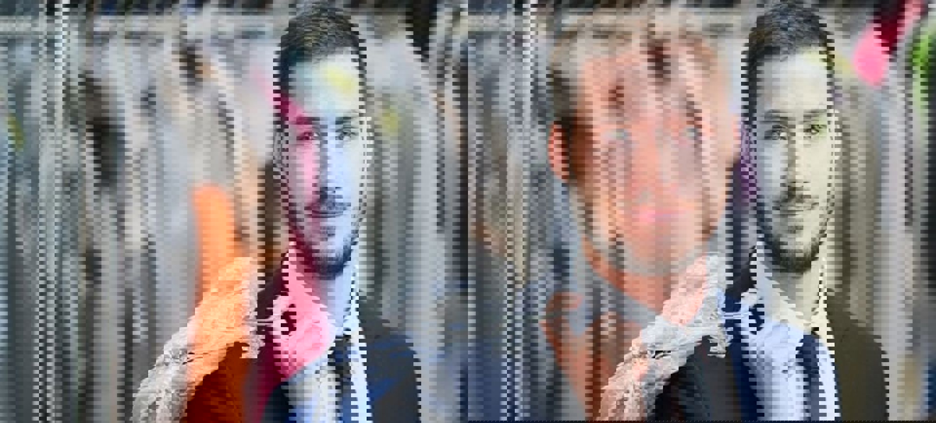 Man Smiles While Holding Dry Cleaning Min